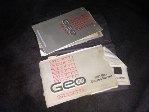1990 Geo Storm GSi - The 1990 Geo Storm GSi owner's manual and maintenance schedule are visible.
