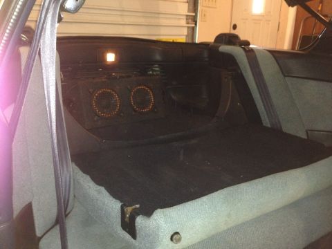1990 Geo Storm GSi - The rear interior of a vehicle shows two aftermarket speakers installed behind the seats.