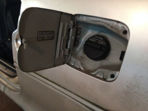 1990 Geo Storm GSi - Close-up of an open fuel filler door with warning labels.