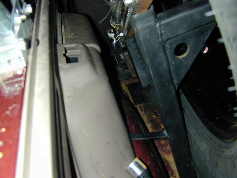 1996 Ford Bronco - Close-up view of the interior components and wheel well of a vehicle, with visible tire and metal framing.
