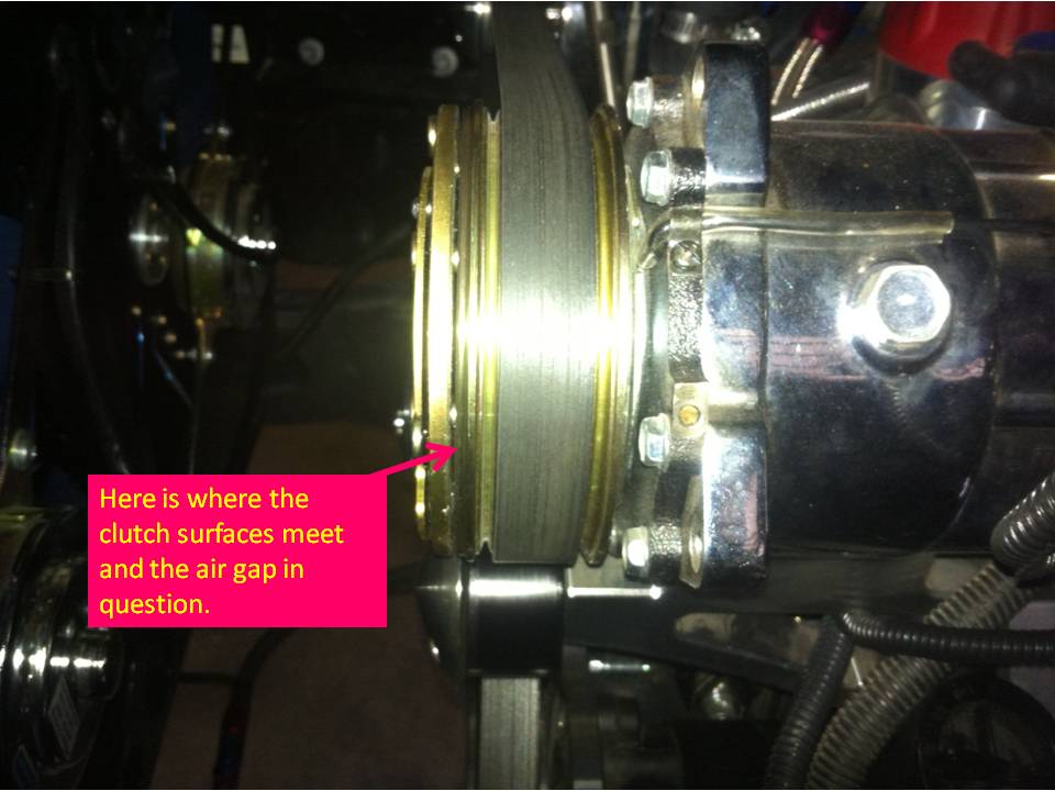Close-up of a clutch assembly with a pink annotation pointing to the clutch surfaces