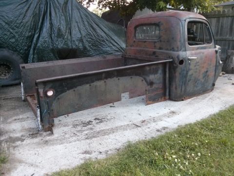 1986 Ford Bronco - This old pickup truck cab and bed are in rough condition, sitting outside.