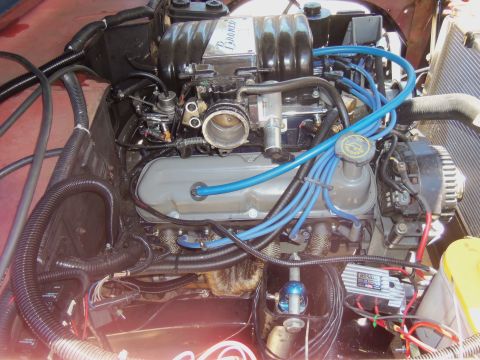 1968 Ford Bronco - The engine bay shows various components including the intake manifold, spark plug wires, and alternator.