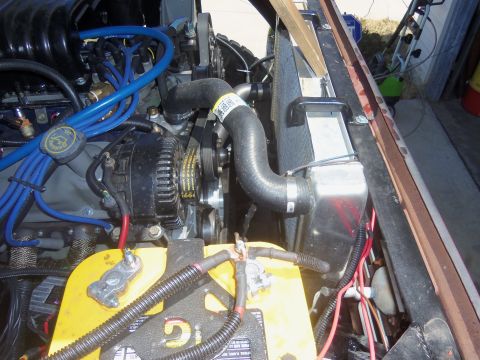 1968 Ford Bronco - Close-up view of a vehicle's engine bay, showing various components like the battery and radiator.