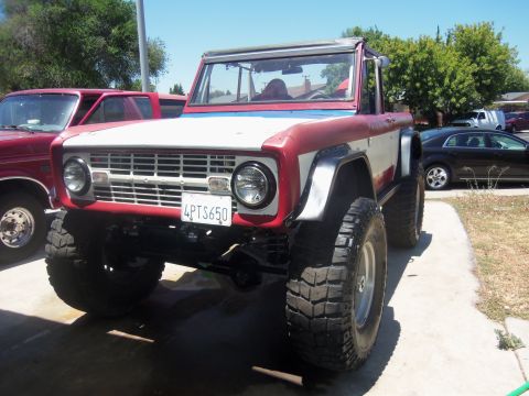 1968 Ford Bronco - This 1968 Ford Bronco, seen here with its first car wash, features a distinctive red and white paint scheme and off-road tires.