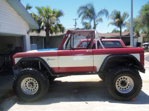 1968 Ford Bronco - This modified Ford Bronco is painted red and white with a blue stripe on the hood.