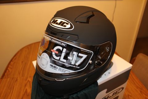 2003 Ford Crown Victoria - matte black HJC CL-17 full-face helmet rests on its HJC box with the visor still showing the product spec sticker.