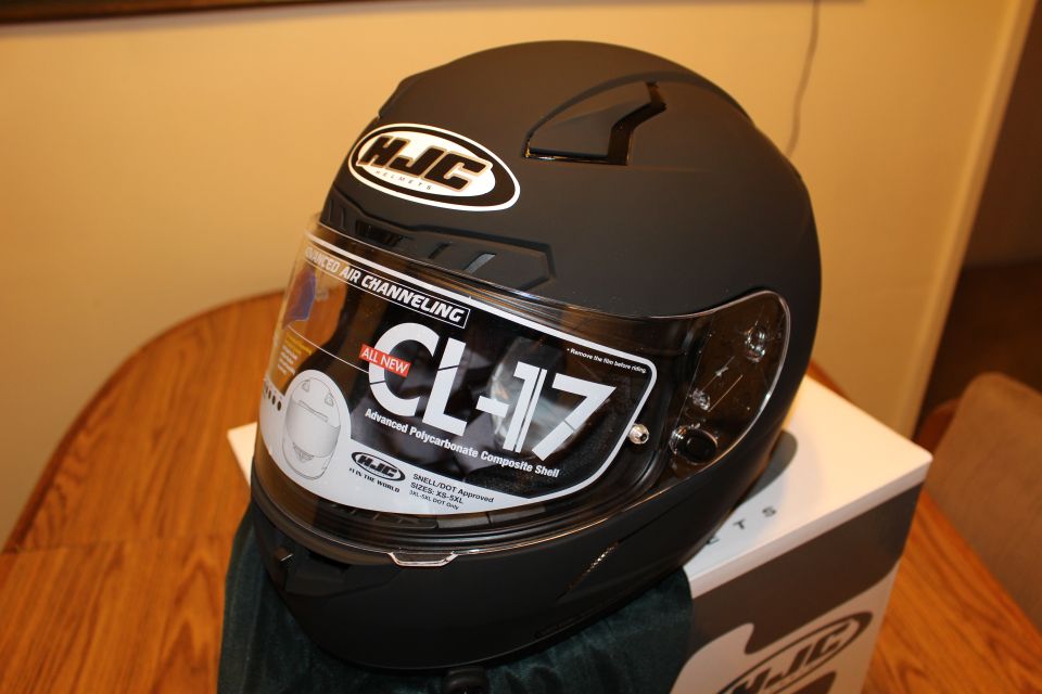 Matte black HJC CL-17 helmet on HJC box, visor sticker visible