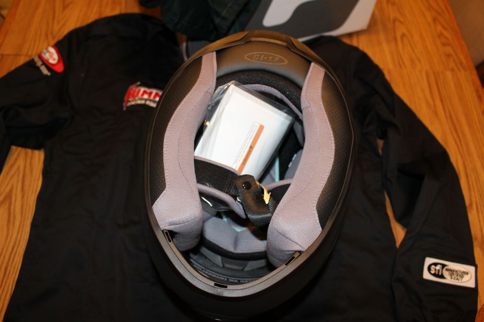 Interior of helmet showing gray padded liner and manual paperwork inside
