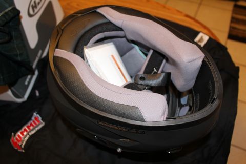 2003 Ford Crown Victoria - Inside view of a helmet showing its gray cheek pads and liner with paperwork inside, the helmet box visible at left.