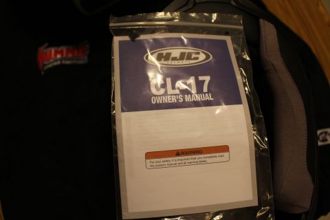 2003 Ford Crown Victoria - HJC CL-17 helmet owners manual sealed in a bag with a printed safety warning.