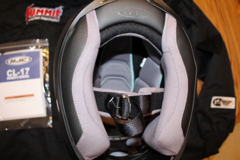 2003 Ford Crown Victoria - Looking down into the open chin bar of a black HJC CL-17 full-face helmet, showing gray interior padding and the chin strap.