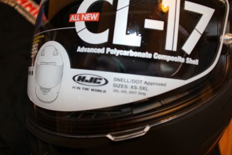 2003 Ford Crown Victoria - Close-up of an HJC CL-17 helmet face shield bearing a promotional decal listing Snell/DOT approval and sizes XS-5XL.