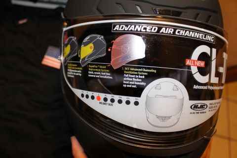 2003 Ford Crown Victoria - HJC CL-17 helmet shield covered by a feature decal describing air channeling and shield replacement, with a printed size chart.