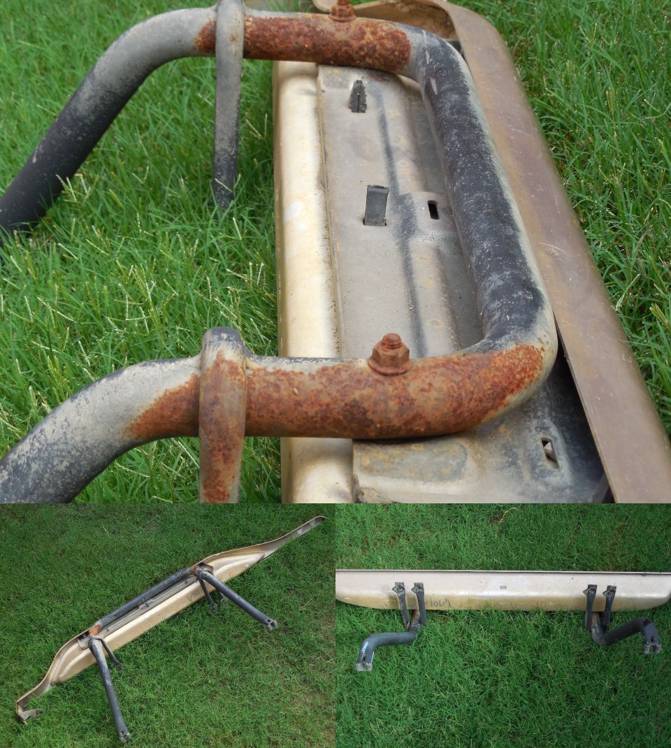 Beige mounting bar with rusty black tubular brackets laid on grass