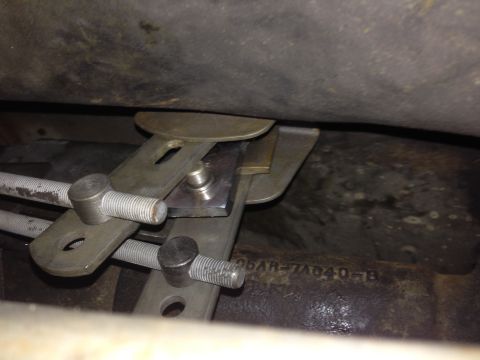 1973 Ford Torino - A close-up view of the mechanical linkage system, showing threaded rods and metal brackets.