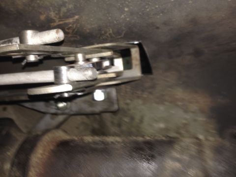 1973 Ford Torino - Close-up of a Hurst floor shift mechanism, showing its intricate metal components and mounting hardware.
