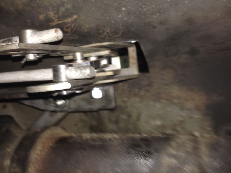 Hurst floor shift mechanism with metal levers and threaded rods, mounted to vehicle undercarriage