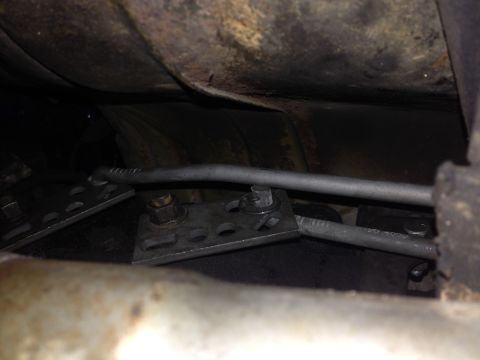 1973 Ford Torino - Close-up view of the shifter linkage mechanism underneath a vehicle.