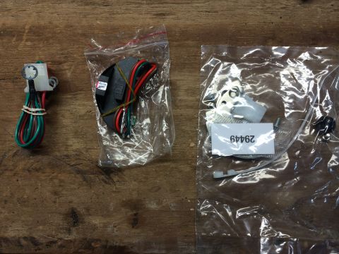 1973 Ford Torino - Electronic ignition components, including wiring and a part number label, are displayed on a wooden background.