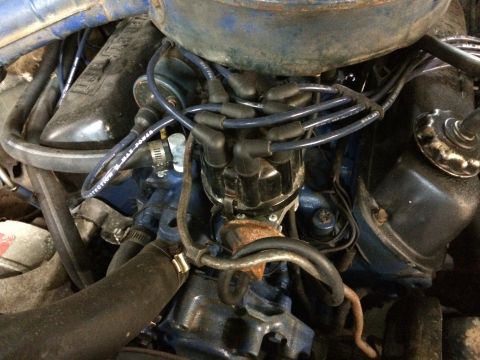 1973 Ford Torino - Close-up view of a vehicle's engine bay, focusing on the distributor and spark plug wires.