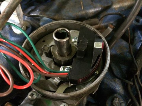 1973 Ford Torino - A close-up view of an automotive ignition distributor, showing its internal components and wiring.