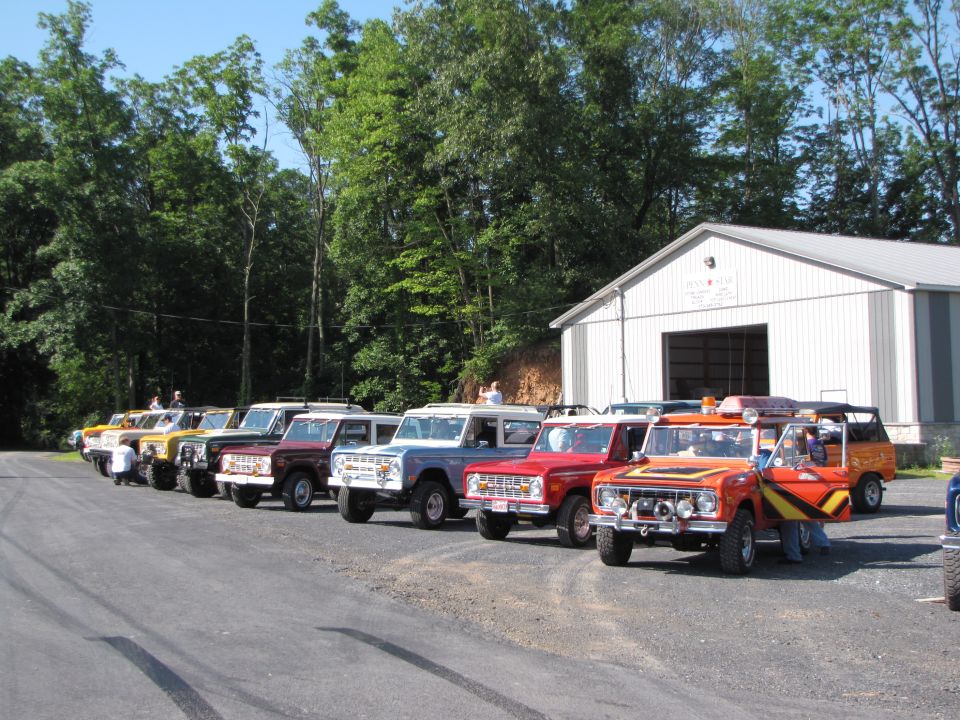 Line of 1979 Ford Broncos parked in front of a building
