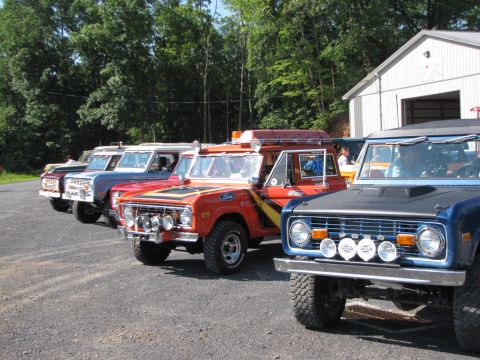 1979 Ford Bronco - Multiple Ford Broncos are lined up in front of a building.