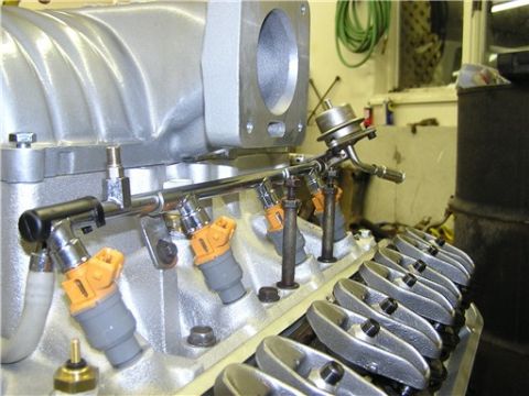 1993 Ford Bronco - Ford V8 engine fuel rail and injectors with valve covers visible.