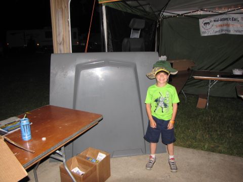 1979 Ford Bronco - A young boy poses in front of a large car hood, wearing an oversized hat and a green t-shirt.