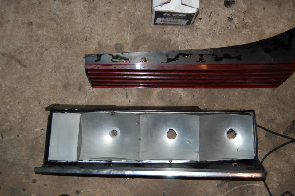car tail light assembly with red lens and silver housing