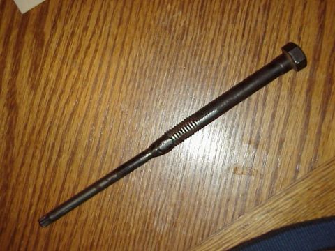1989 Ford Bronco - A Torx bolt with a hex head is shown on a wooden surface. The registry label indicates it is from a 1989 Ford Bronco, but this is not verif…