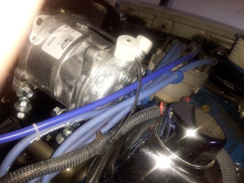 1976 Ford Ranchero - Engine bay detail an AC compressor and spark plug wires.
