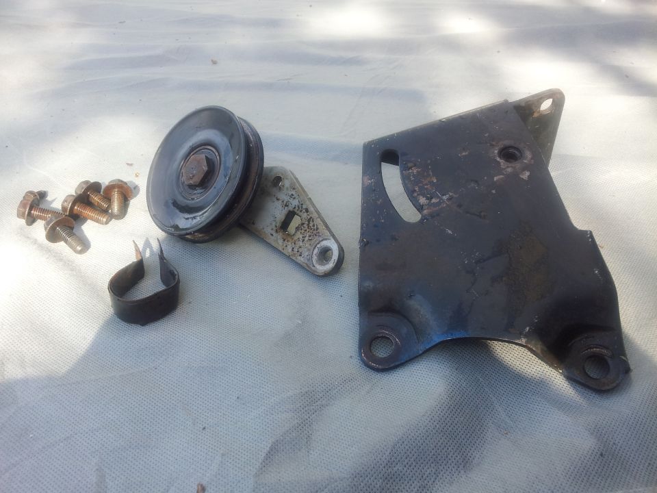Air conditioning bracket and pulley with bolts and clamp