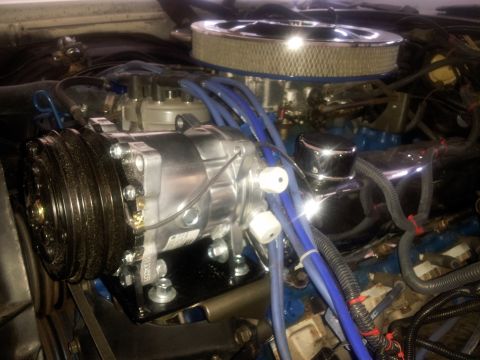 1976 Ford Ranchero - Engine bay detail showing an AC compressor and related components, with visible "SUPERMOTORS" text.