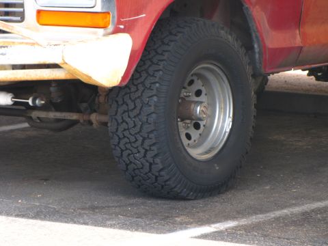 1978 Ford Bronco - Close-up of the front wheel and fender of a red 1978 Ford Bronco, an aftermarket wheel.