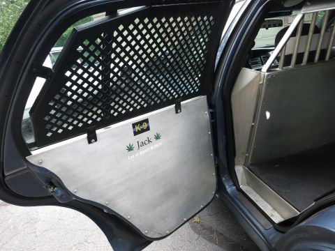 2001 Ford Crown Victoria - Interior view of a police vehicle's rear passenger area, modified for K-9 transport.