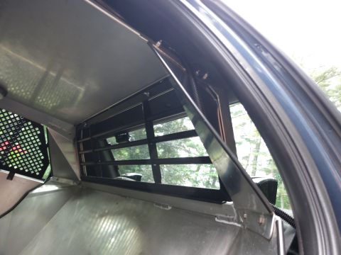 2001 Ford Crown Victoria - Looking through the partition of a vehicle's interior towards the outside.