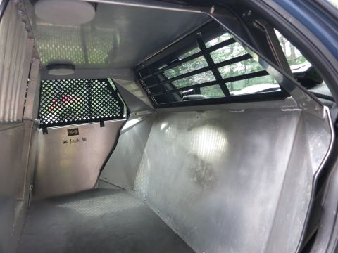 2001 Ford Crown Victoria - This vehicle's interior has been converted into a K-9 transport unit, durable metal walls and a secure cage.