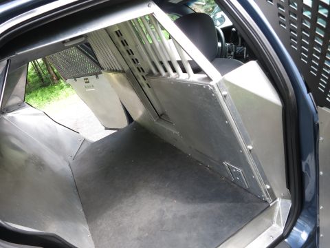 2001 Ford Crown Victoria - Interior view of a 2001 Ford Crown Victoria modified with a police partition and cage.