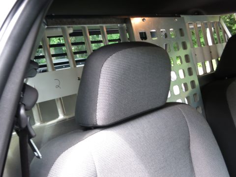 2001 Ford Crown Victoria - The interior of a vehicle is visible, with a partition separating the front and rear compartments.