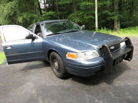 2001 Ford Crown Victoria - This 2001 Ford Crown Victoria police car is shown from the front quarter angle with the driver's door ajar.