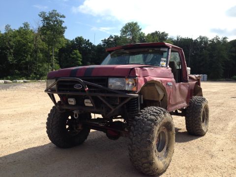 1988 Ford Bronco - This heavily modified Ford truck features oversized off-road tires, a custom brush guard, and a lifted suspension, suggesting it's built fo…