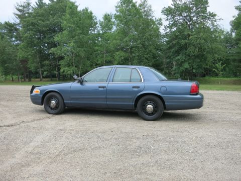 2001 Ford Crown Victoria - This 2001 Ford Crown Victoria sedan is shown from the side in a gravel lot.