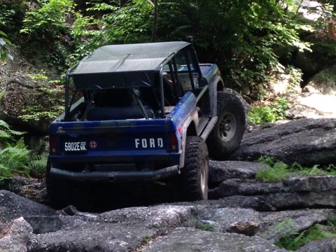 1988 Ford Bronco - This modified Ford Bronco tackles a challenging off-road course, its capabilities on a rocky trail.