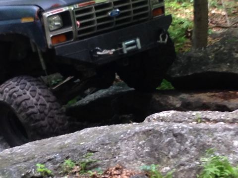 1988 Ford Bronco - This vehicle is navigating a rocky trail, with its front tire visible on the left.