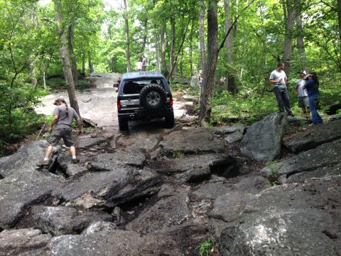 1988 Ford Bronco - Bronco tackling a tough off-road course in the woods.