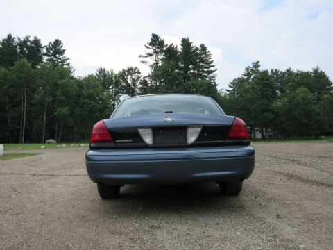 2001 Ford Crown Victoria - Rear view of a blue 2001 Ford Crown Victoria, showing its distinctive taillights and rear bumper.