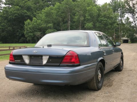 2001 Ford Crown Victoria - Rear view of a 2001 Ford Crown Victoria, showing its taillights and trunk.
