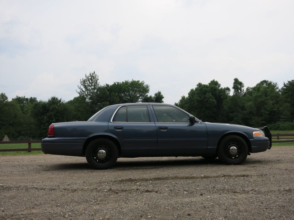 Blue 2001 Ford Crown Victoria police car, side view